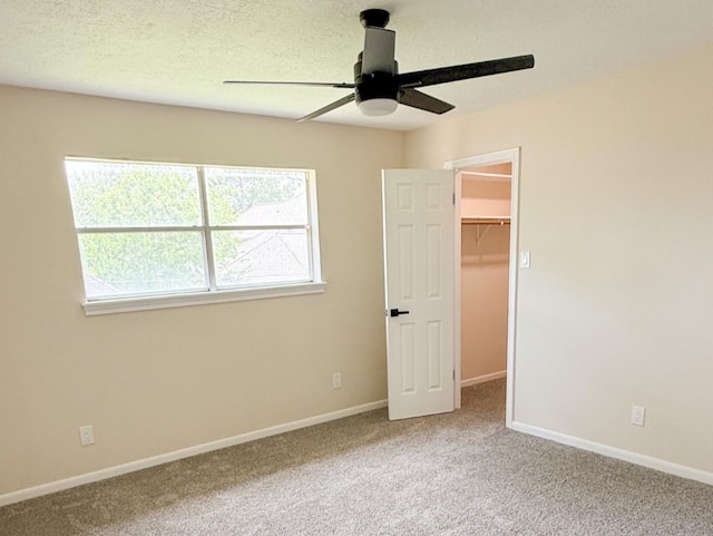 16627 Aldenham Pl, Spring, TX 77379 - unfurnished bedroom with carpet floors, a walk in closet, and ceiling fan