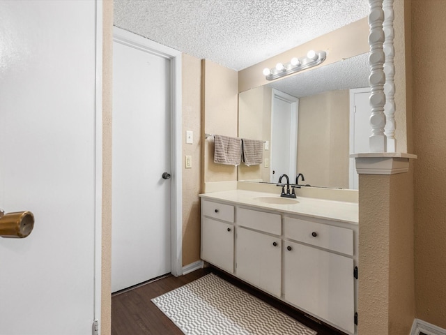 1505 Ward Rd Unit 215, Baytown, TX 77520 - bathroom featuring wood finished floors, vanity, and a textured ceiling