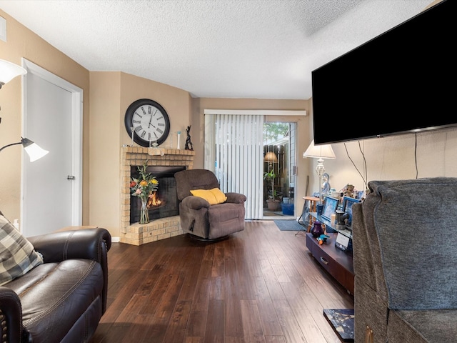 1505 Ward Rd Unit 215, Baytown, TX 77520 - living room featuring hardwood / wood-style flooring, a fireplace, and a textured ceiling