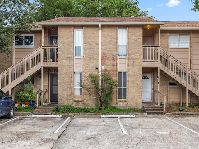 1505 Ward Rd Unit 215, Baytown, TX 77520 - view of building exterior featuring stairs and uncovered parking