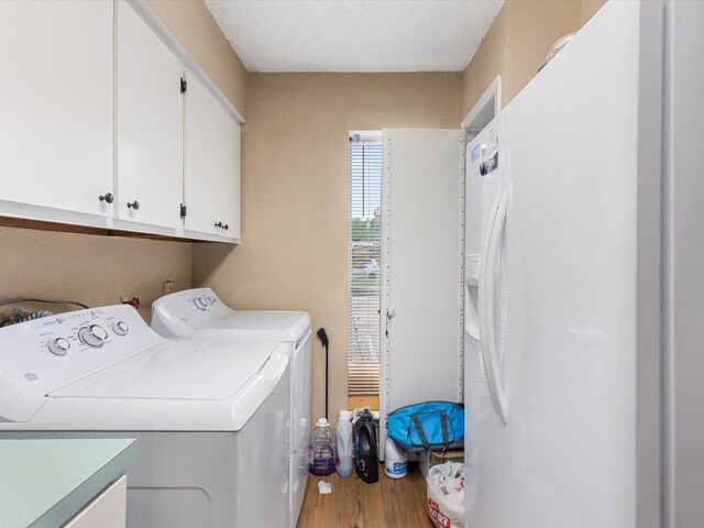 1505 Ward Rd Unit 215, Baytown, TX 77520 - laundry area with cabinet space, washer and clothes dryer, and wood finished floors
