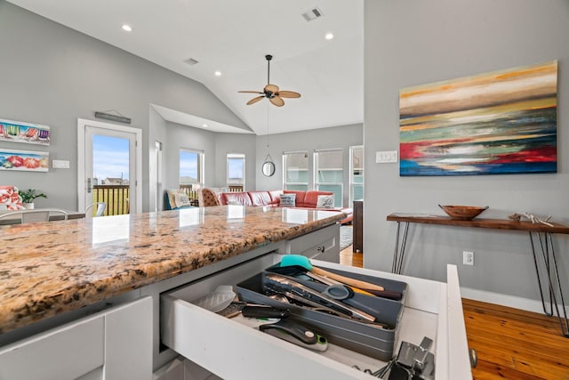 18607 Warrior Rd, Galveston, TX 77554 - kitchen with hardwood / wood-style floors, light stone countertops, lofted ceiling, a ceiling fan, and recessed lighting