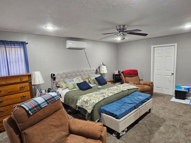 518 Bowie St, Liberty, TX 77575 - bedroom featuring a wall unit AC, carpet flooring, a textured ceiling, and ceiling fan