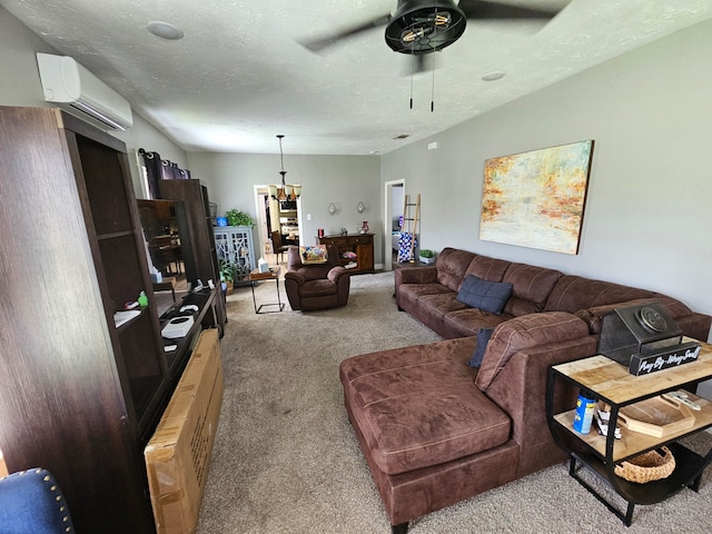 518 Bowie St, Liberty, TX 77575 - carpeted living area featuring a wall unit AC, ceiling fan, a chandelier, and a textured ceiling