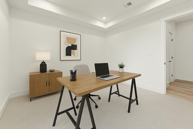 1604 Mary St, Houston, TX 77026 - home office featuring light colored carpet, a raised ceiling, and recessed lighting