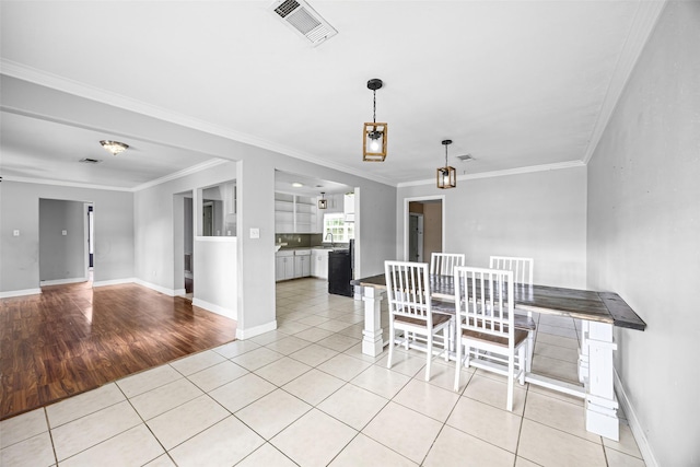 4535 Clermont Ave, Groves, TX 77619 - dining room with crown molding and light tile patterned floors