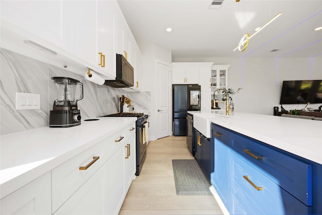 2422 Briley St, Houston, TX 77004 - kitchen featuring black appliances, blue cabinets, white cabinets, light countertops, and backsplash