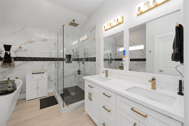 2422 Briley St, Houston, TX 77004 - bathroom with a marble finish shower, double vanity, a soaking tub, and wood finished floors