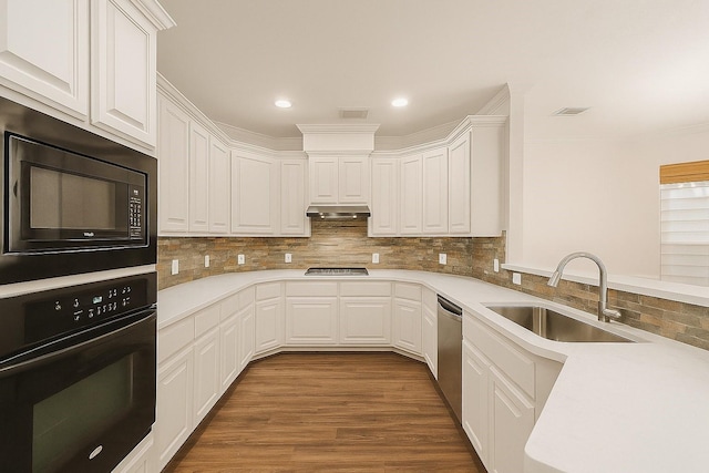 1517 Asbury St, Houston, TX 77007 - kitchen with black appliances, light countertops, white cabinetry, recessed lighting, and ornamental molding