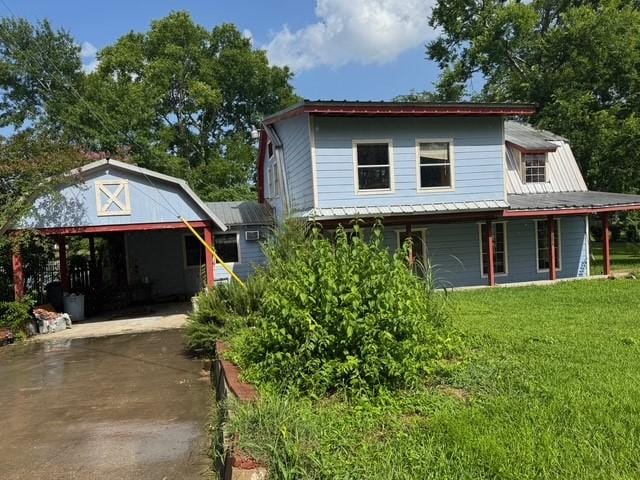 771 Governor Wood Dr, Point Blank, TX 77364 - country-style home featuring driveway, a metal roof, a front lawn, and covered porch