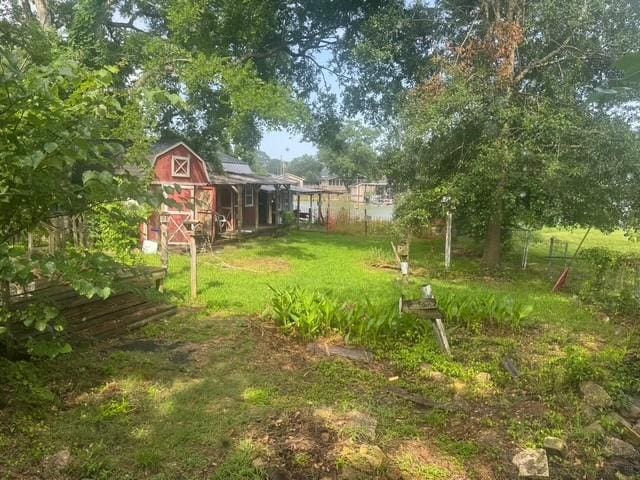 771 Governor Wood Dr, Point Blank, TX 77364 - view of green lawn featuring a shed
