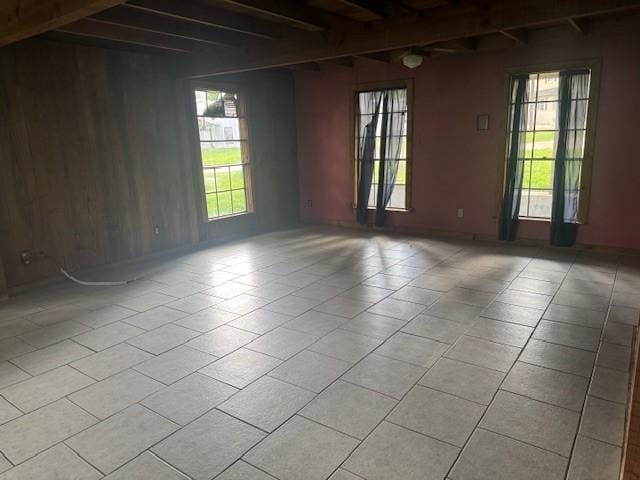 771 Governor Wood Dr, Point Blank, TX 77364 - unfurnished room with plenty of natural light, beam ceiling, and light tile patterned flooring