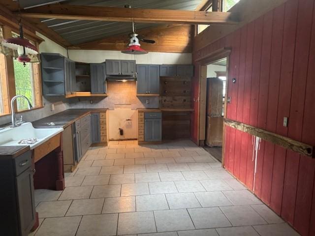 771 Governor Wood Dr, Point Blank, TX 77364 - kitchen featuring under cabinet range hood, wooden walls, decorative backsplash, gray cabinets, and open shelves