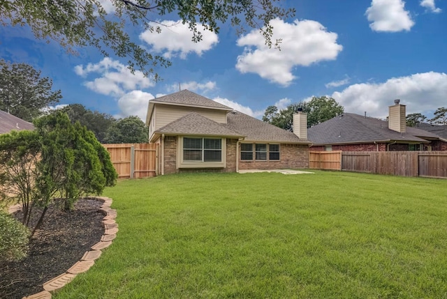 71 N Merryweather Cir, Conroe, TX 77384 - rear view of property with a fenced backyard, brick siding, and roof with shingles