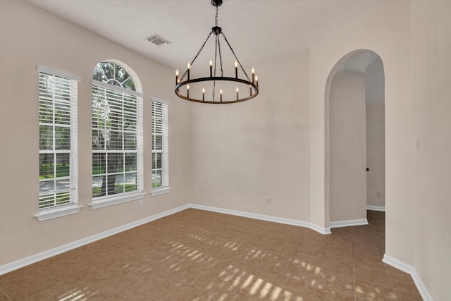 71 N Merryweather Cir, Conroe, TX 77384 - empty room with arched walkways, a chandelier, and tile patterned floors