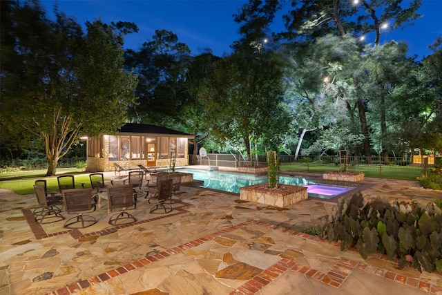 603 W Friar Tuck Ln, Houston, TX 77024 - pool at night with an outdoor structure, a patio, and an exterior structure