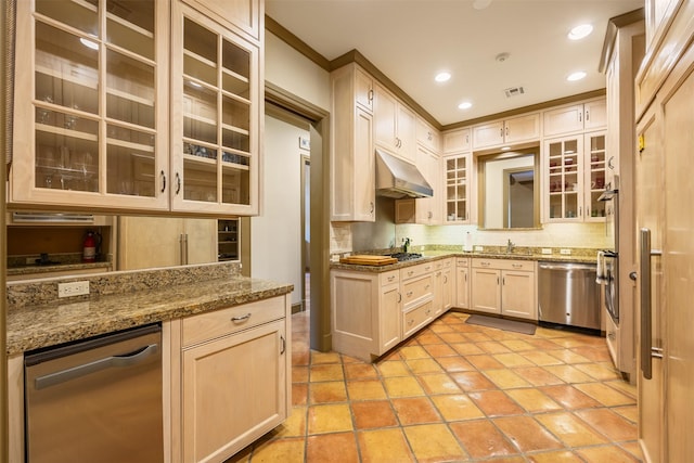 603 W Friar Tuck Ln, Houston, TX 77024 - kitchen featuring appliances with stainless steel finishes, under cabinet range hood, glass insert cabinets, tasteful backsplash, and light stone countertops