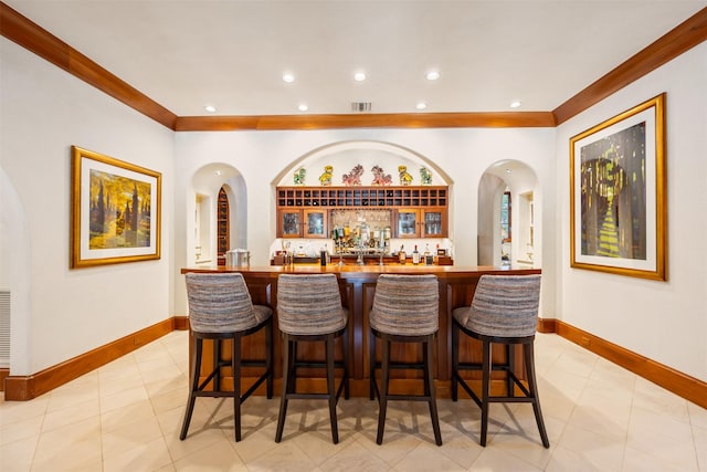 603 W Friar Tuck Ln, Houston, TX 77024 - indoor wet bar featuring recessed lighting, ornamental molding, arched walkways, and light tile patterned flooring