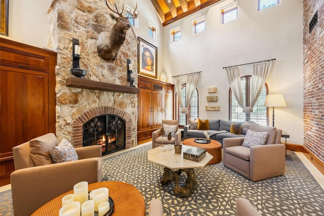 603 W Friar Tuck Ln, Houston, TX 77024 - living area featuring a high ceiling, a stone fireplace, and beamed ceiling