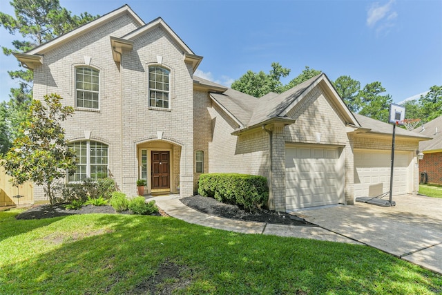 227 Fairwind Trail Dr, The Woodlands, TX 77385 - view of front facade featuring brick siding, driveway, an attached garage, and a front lawn