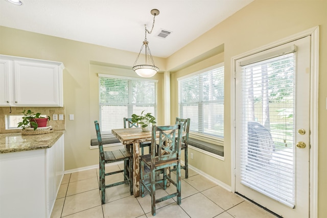 227 Fairwind Trail Dr, The Woodlands, TX 77385 - dining area with light tile patterned flooring and baseboards