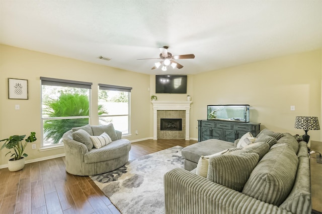 227 Fairwind Trail Dr, The Woodlands, TX 77385 - living area with ceiling fan, healthy amount of natural light, wood finished floors, and a fireplace