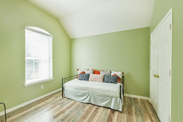 227 Fairwind Trail Dr, The Woodlands, TX 77385 - bedroom with lofted ceiling and wood finished floors