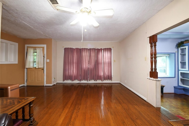 3614 Billingsley St, Houston, TX 77009 - unfurnished living room featuring wood finished floors, ceiling fan, healthy amount of natural light, and a textured ceiling