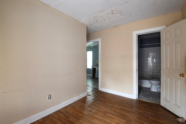 3614 Billingsley St, Houston, TX 77009 - unfurnished bedroom featuring wood finished floors, a textured ceiling, and connected bathroom