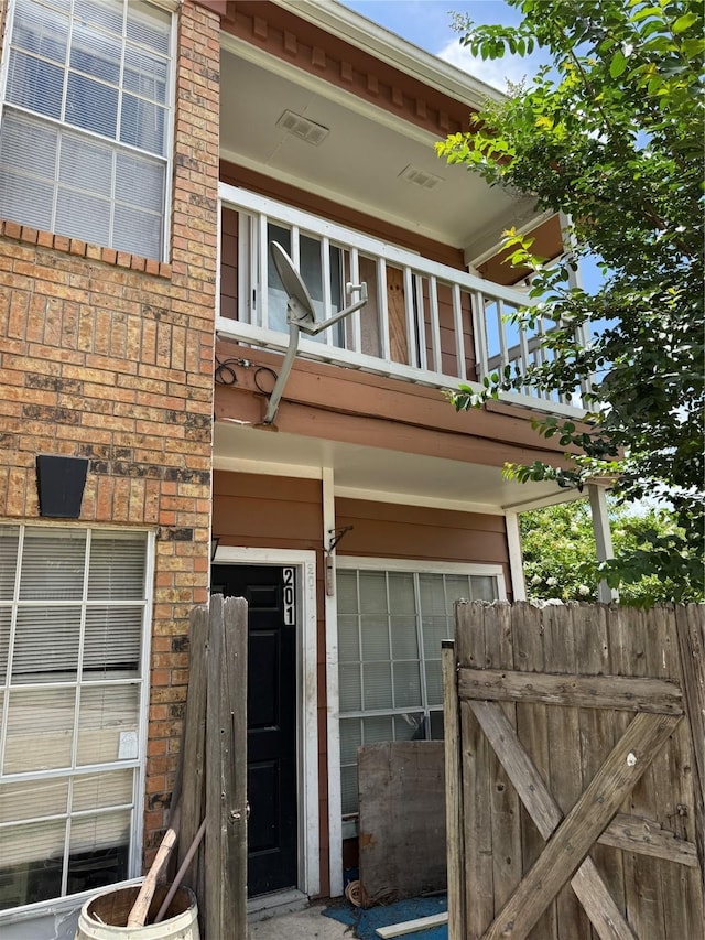 12380 Sandpiper Dr Unit 201, Houston, TX 77035 - view of exterior entry with a balcony and brick siding