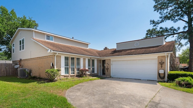 606 Pinebrook Ln, Baytown, TX 77521 - view of front of house featuring brick siding, driveway, an attached garage, and roof with shingles