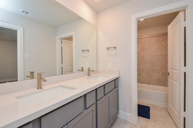 9522 Rialto Creek Dr, Cypress, TX 77433 - full bath with double vanity, tile patterned floors, and washtub / shower combination