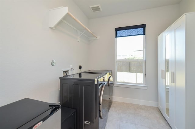 9522 Rialto Creek Dr, Cypress, TX 77433 - washroom with washing machine and dryer and light tile patterned flooring