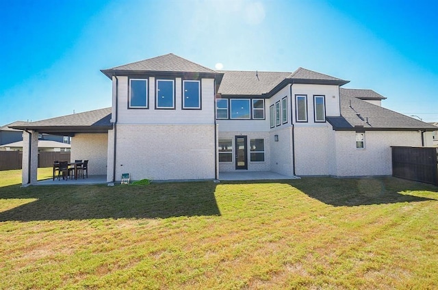 9522 Rialto Creek Dr, Cypress, TX 77433 - rear view of house with a patio, a fenced backyard, a shingled roof, and brick siding