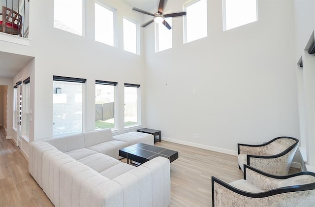 9522 Rialto Creek Dr, Cypress, TX 77433 - living area featuring a high ceiling, a ceiling fan, plenty of natural light, and light wood-type flooring