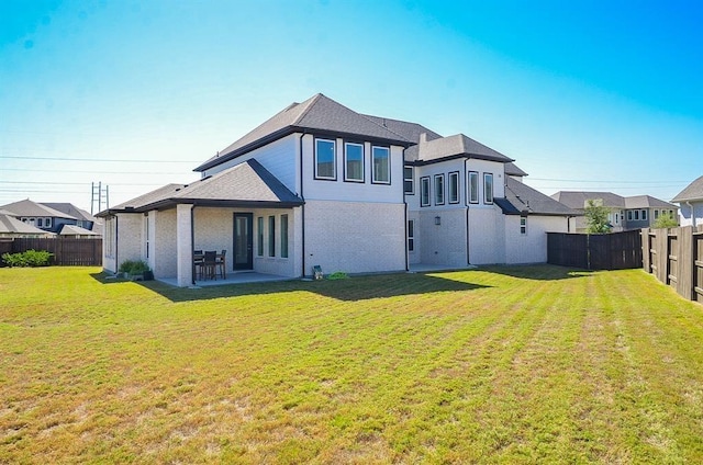 9522 Rialto Creek Dr, Cypress, TX 77433 - rear view of house with a fenced backyard, a patio, and a shingled roof