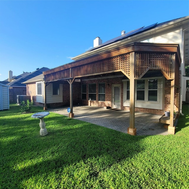 110 Greenridge Cir, League City, TX 77573 - back of house featuring brick siding, a patio, a yard, a chimney, and a deck