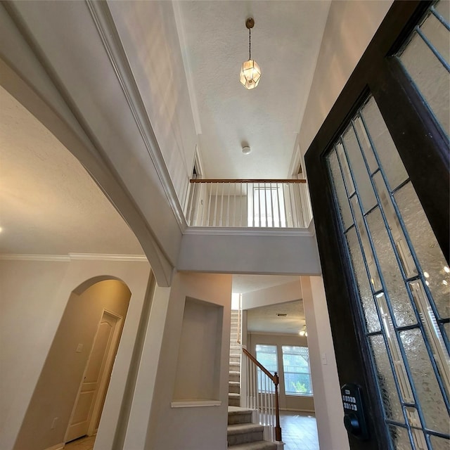 110 Greenridge Cir, League City, TX 77573 - stairway with a towering ceiling, arched walkways, and crown molding