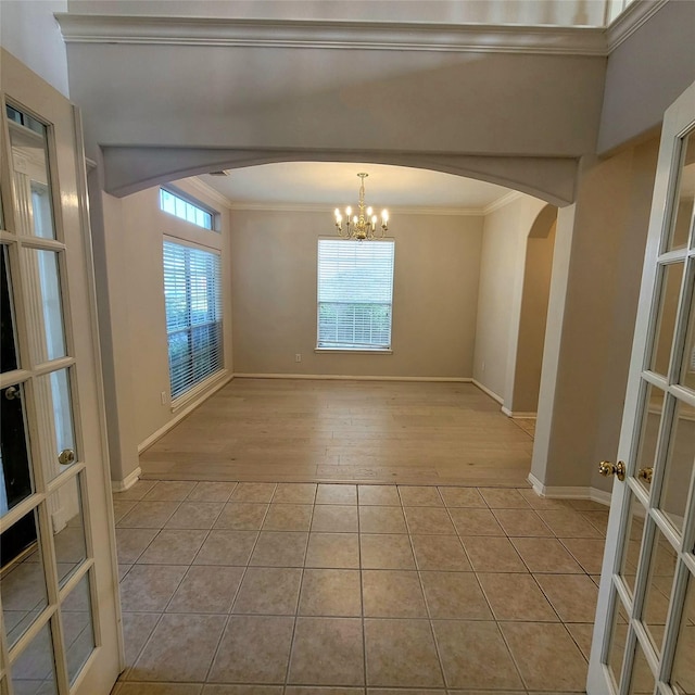 110 Greenridge Cir, League City, TX 77573 - empty room featuring arched walkways, crown molding, healthy amount of natural light, and light tile patterned flooring