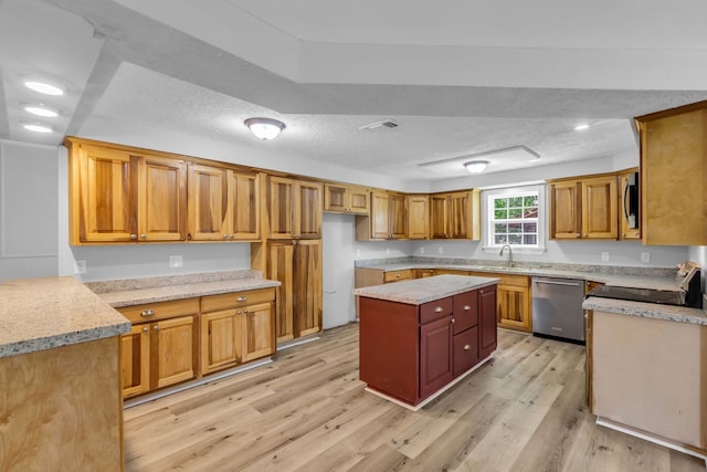 10650 Forest Creek Dr, Conroe, TX 77318 - kitchen featuring stainless steel appliances, light wood finished floors, a textured ceiling, brown cabinets, and a center island