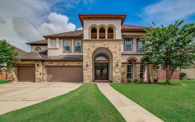 5719 Avon Landing Ln, Sugar Land, TX 77479 - mediterranean / spanish-style home featuring french doors, a balcony, stucco siding, and a front lawn