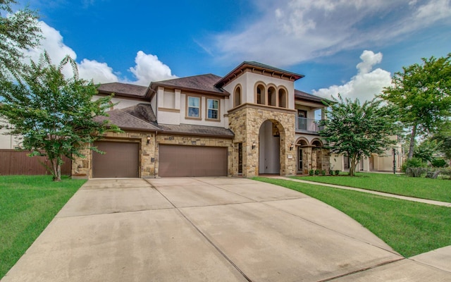 5719 Avon Landing Ln, Sugar Land, TX 77479 - mediterranean / spanish house with stucco siding, driveway, stone siding, and a balcony