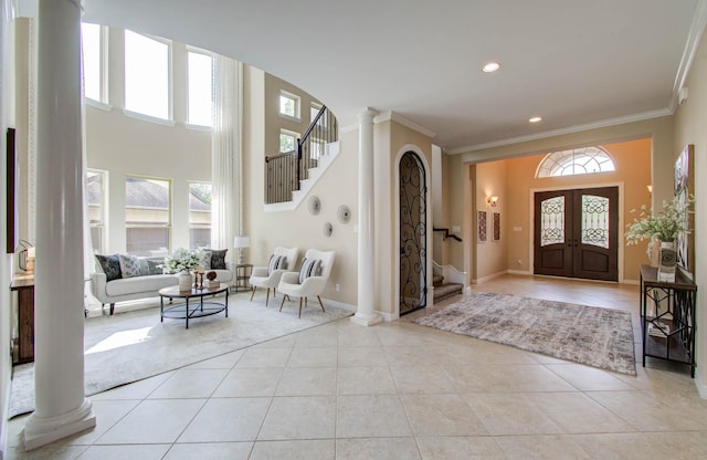 5719 Avon Landing Ln, Sugar Land, TX 77479 - entrance foyer featuring decorative columns, stairway, light tile patterned floors, crown molding, and recessed lighting