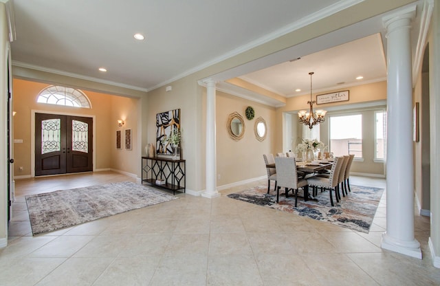 5719 Avon Landing Ln, Sugar Land, TX 77479 - entrance foyer featuring ornate columns, crown molding, light tile patterned floors, recessed lighting, and french doors