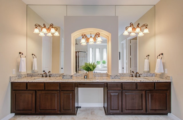 5719 Avon Landing Ln, Sugar Land, TX 77479 - full bathroom featuring double vanity, a chandelier, and a shower with shower door