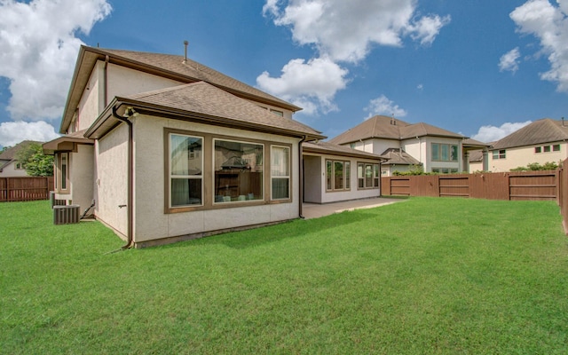 5719 Avon Landing Ln, Sugar Land, TX 77479 - back of house with a fenced backyard, stucco siding, and a shingled roof