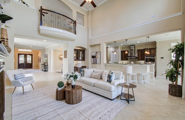 5719 Avon Landing Ln, Sugar Land, TX 77479 - living room featuring crown molding, light tile patterned flooring, a towering ceiling, and ceiling fan