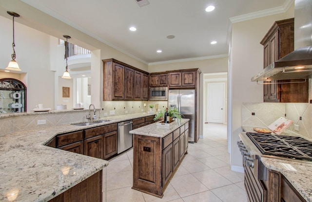 5719 Avon Landing Ln, Sugar Land, TX 77479 - kitchen with appliances with stainless steel finishes, wall chimney exhaust hood, backsplash, light stone countertops, and pendant lighting