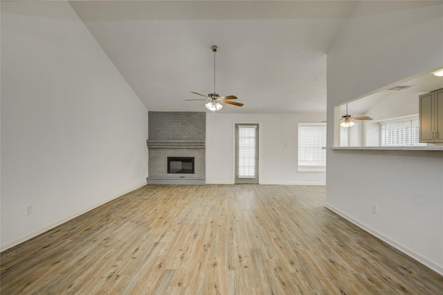 7502 Dawnbriar Ct, Houston, TX 77489 - unfurnished living room with vaulted ceiling, a ceiling fan, light wood-type flooring, and a fireplace