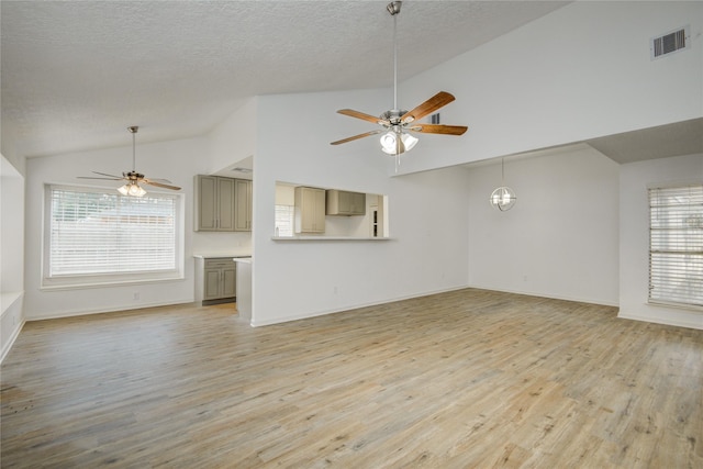 7502 Dawnbriar Ct, Houston, TX 77489 - unfurnished living room featuring a ceiling fan, light wood-type flooring, a textured ceiling, and high vaulted ceiling